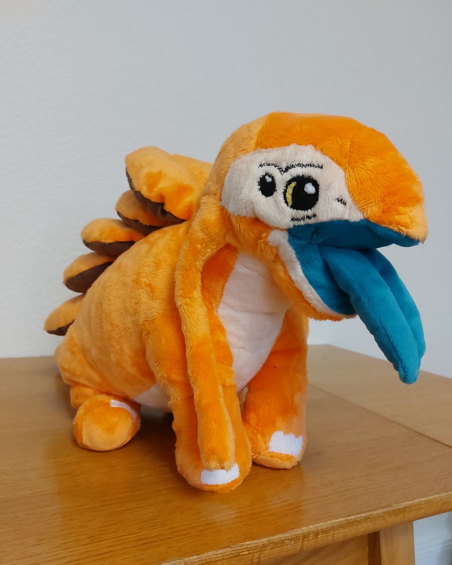 Handgefertigte orange Plüschfigur mit gesticktem Gesicht